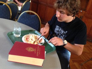A camper reads a first edition of the classic "Greater Magic" while eating lunch!